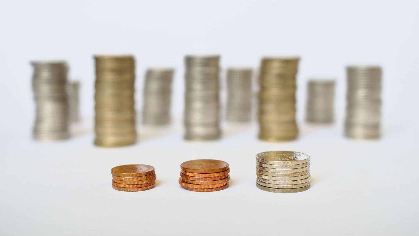 Stack of British coins on a white table.