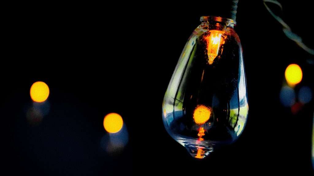 Flickering lightbulb with a black background.