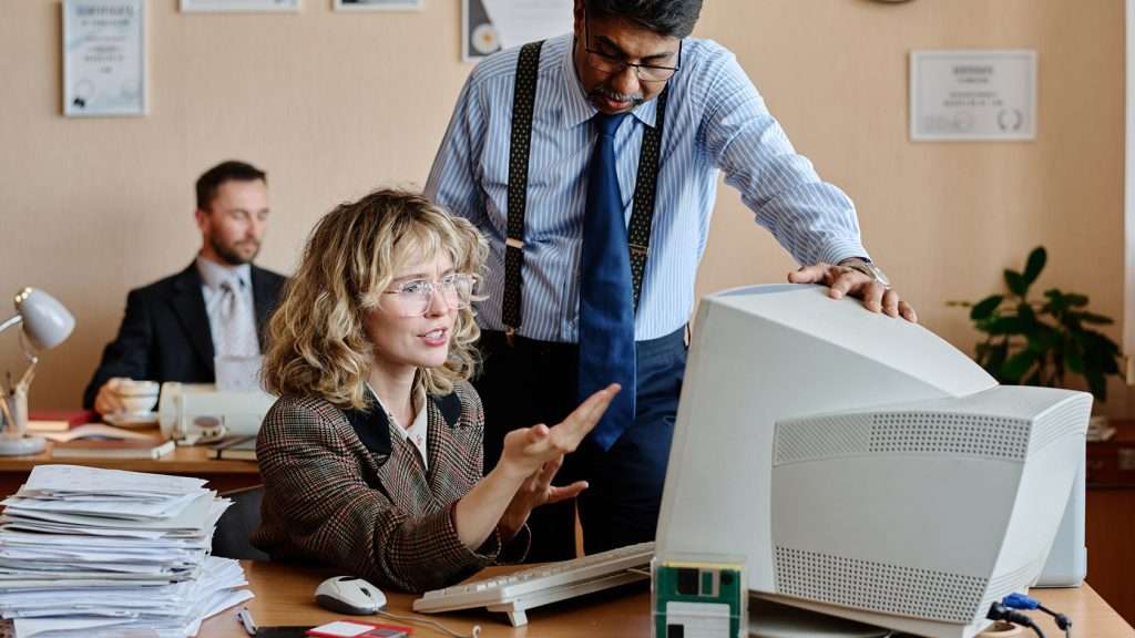 Office colleagues being frustrated with the old office equipment.