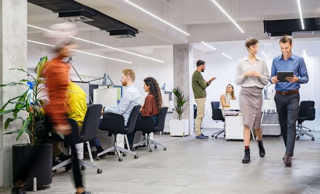 People moving around in a busy office