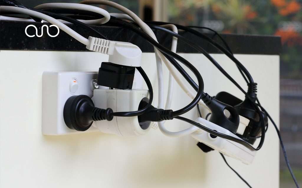 Overlaoded extension cable on an office desk.